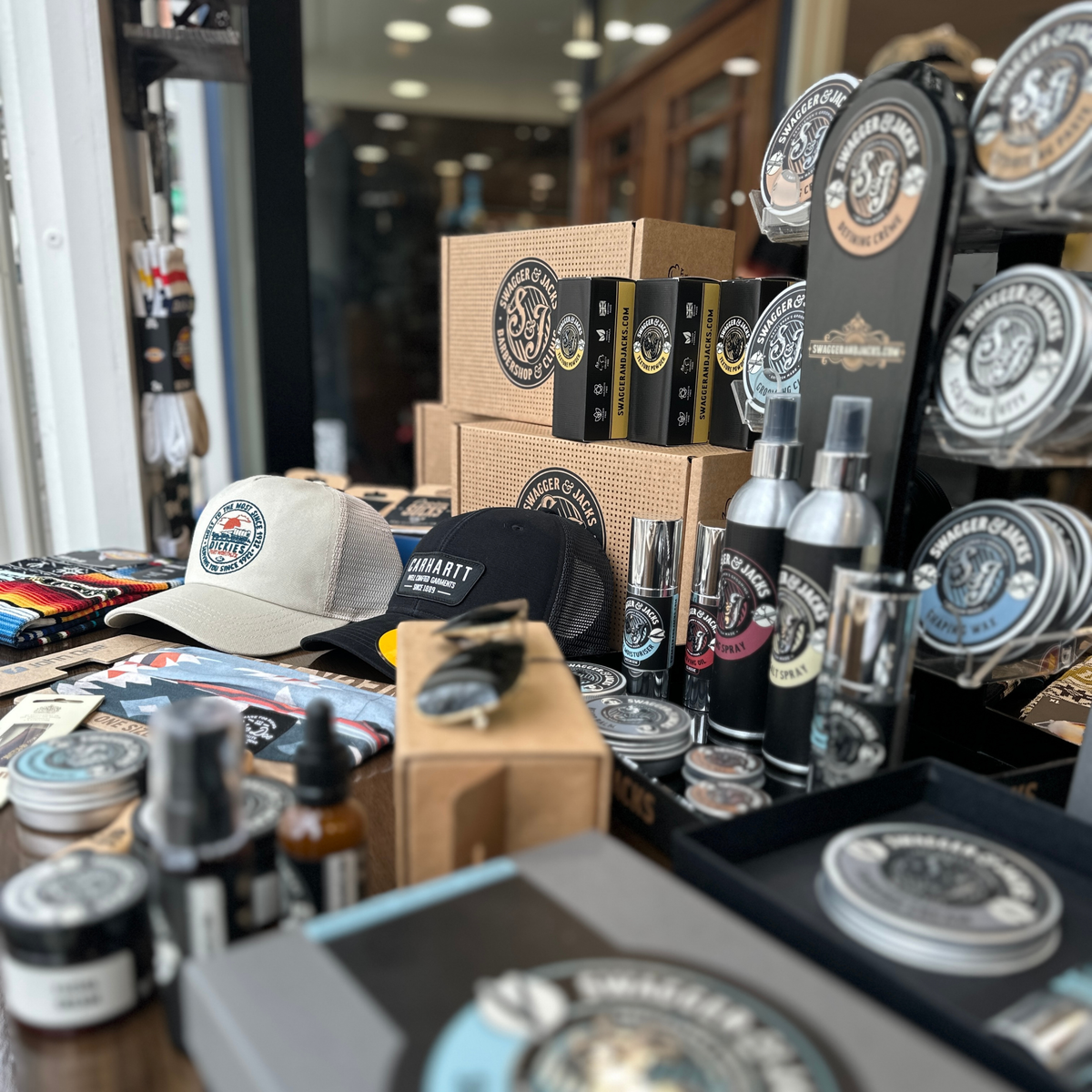 Swagger & Jacks grooming products and caps on display in the Norwich barbershop