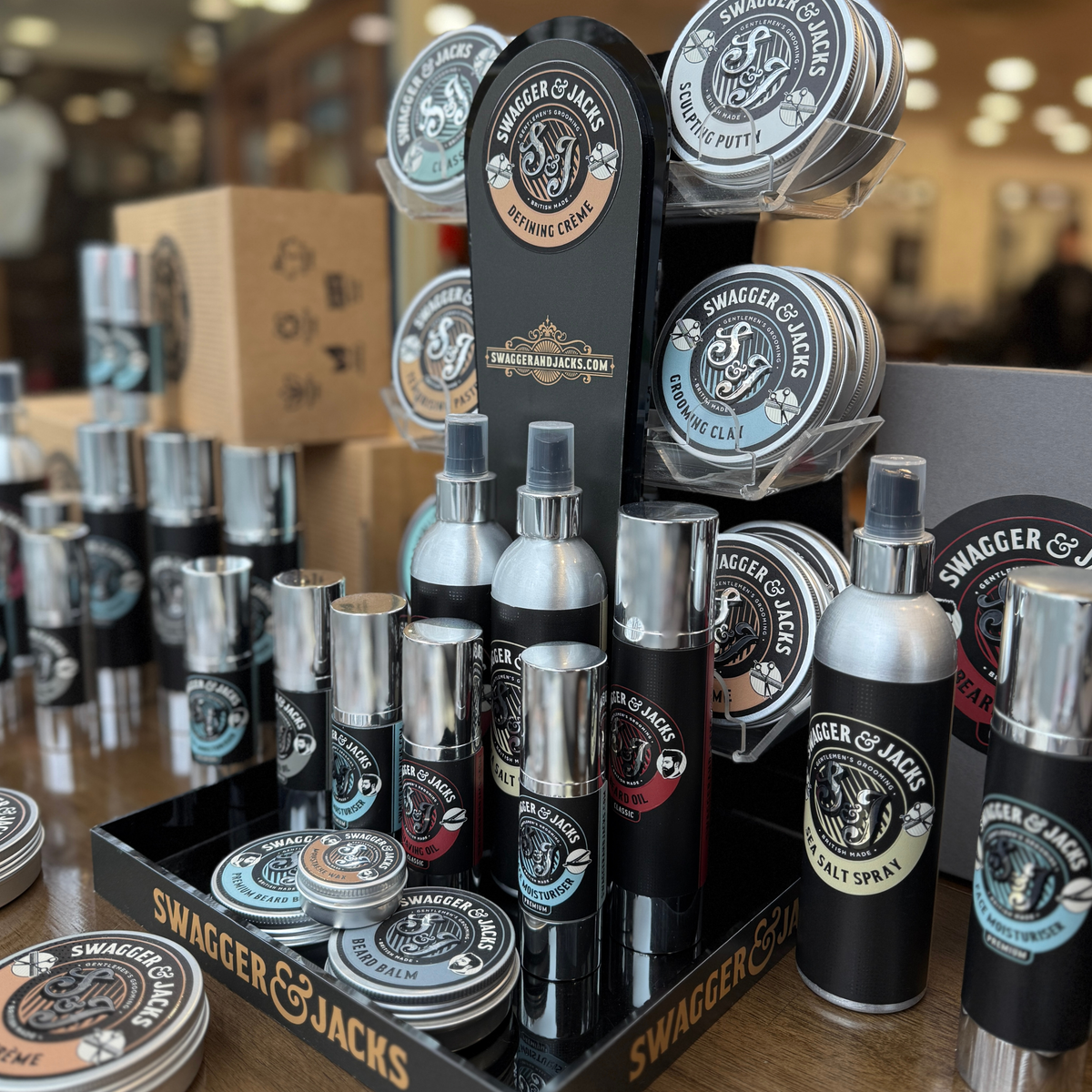 Swagger & Jacks hair styling tins and sprays on a display stand in the barbershop